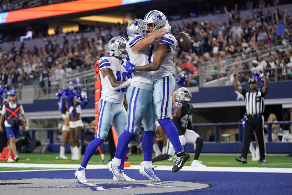 Dallas Cowboys' Hunter Luepke, center left, and Dennis Houston, right, celebrate a touchdown scored by Luepke in the first half of a preseason NFL football game against the Las Vegas Raiders in Arlington, Texas, Saturday, Aug. 26, 2023. (AP Photo/Sam Hodde)