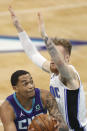 Charlotte Hornets forward P.J. Washington, left, is defended by Orlando Magic forward Ignas Brazdeikis during the first half of an NBA basketball game in Charlotte, N.C., Friday, May 7, 2021. (AP Photo/Nell Redmond)