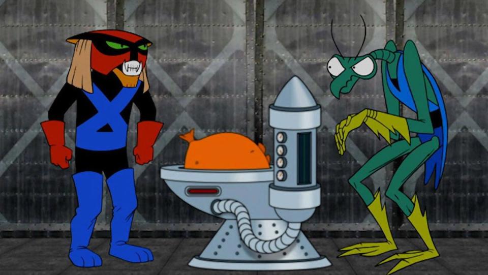 Weird cartoon aliens Brak and Zorak stand near a machine holding an orange balloon like ball