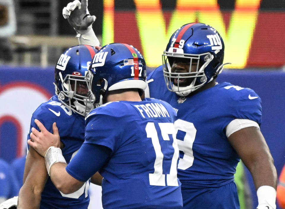 New York Giants quarterback Jake Fromm (17) congratulates wide receiver Darius Slayton, left, along with offensive tackle Korey Cunningham (79) after a touchdown by Slayton during the fourth quarter of an NFL football game against the Washington Football Team, Saturday, Jan. 9, 2021, in East Rutherford, N.J. (AP Photo/Bill Kostroun)