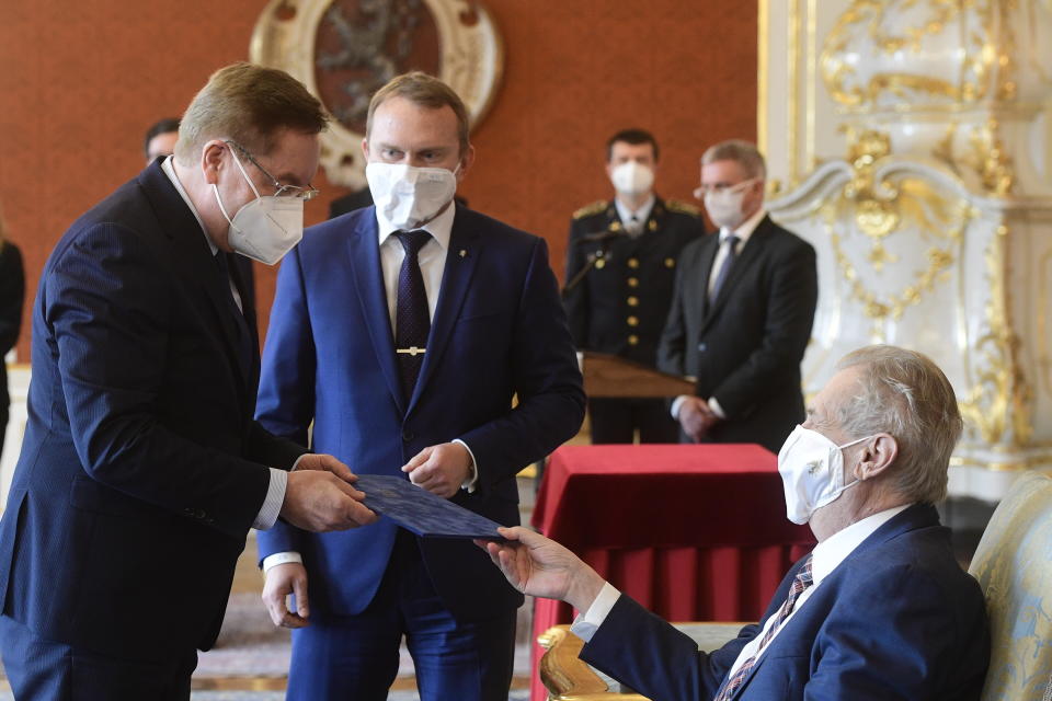 Czech president Milos Zeman, right, appoints Petr Arenberger, left, director of the Prague-Vinohrady Teaching Hospital, as the new Czech health minister, replacing the sacked Jan Blatny, in Prague, Czech Republic, Wednesday, April 7, 2021. (Roman Vondrous/CTK via AP)