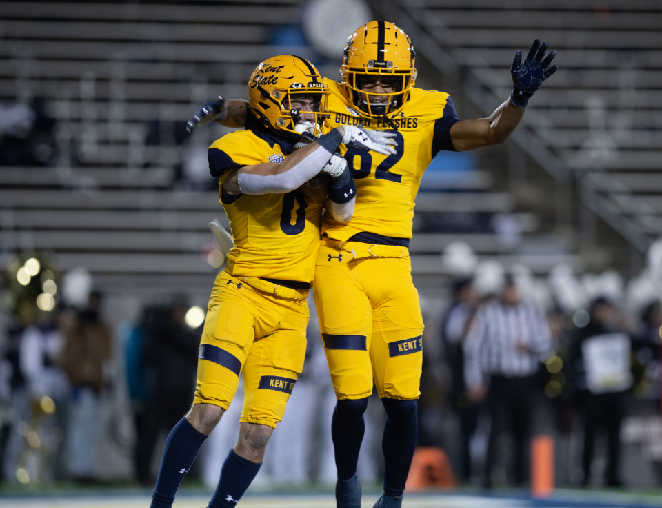 Kent State's Luke Floriea (left) celebrates with teammate Jameel Gardner Jr. after scoring on a 19-yard reception in the second quarter against the University of Akron on Wednesday in Akron.