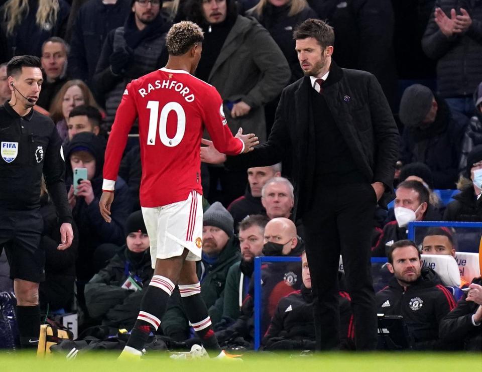 Manchester United caretaker manager Michael Carrick (right) shakes hands with Marcus Rashford at Chelsea (Adam Davy/PA) (PA Wire)