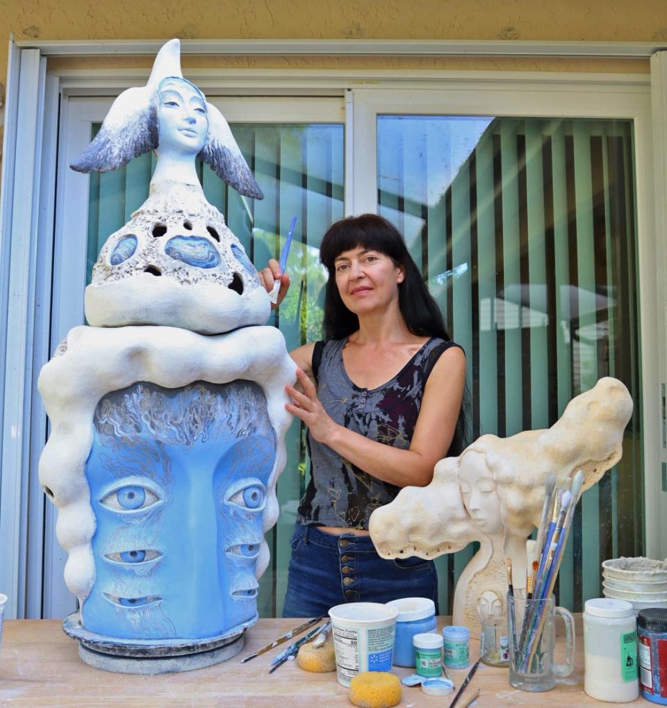 Ukrainian-born artist Natasha Dikareva with some of her sculptures, which are on display in a show at Art Center Sarasota.