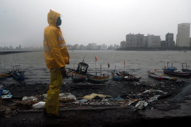 A Mumbai police official stands guard off the coast of the Arabic sea in Mumbai