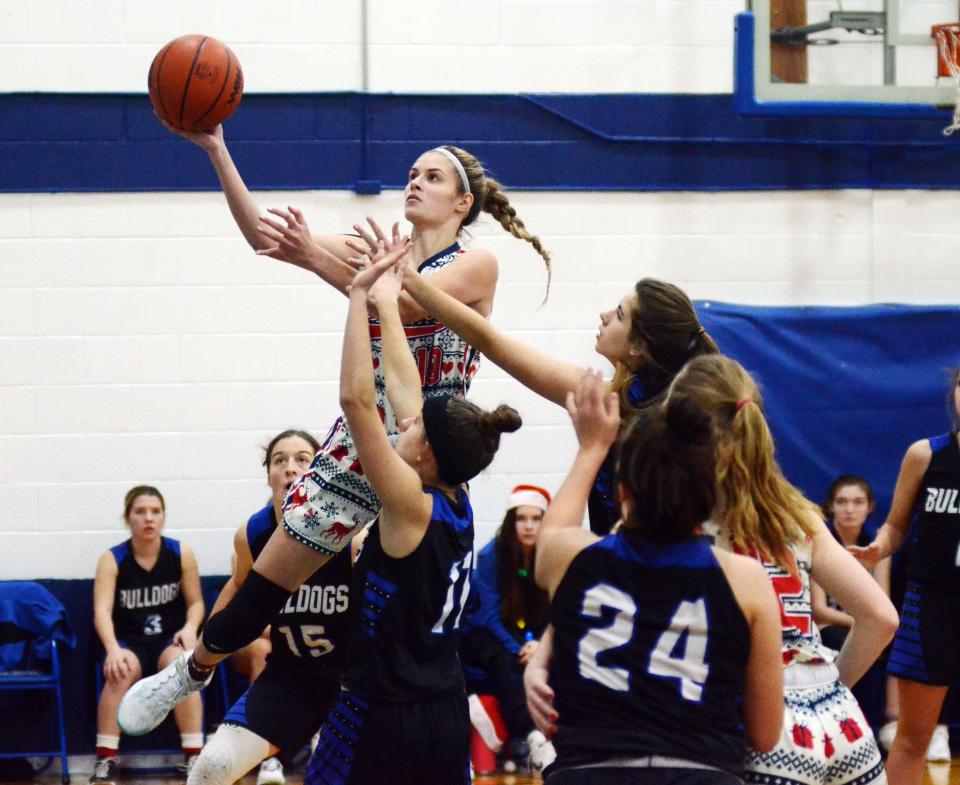 Mackinaw City senior forward Madison Smith drives to the hoop and scores in front of the Inland Lakes defense in the first half of Wednesday's game.