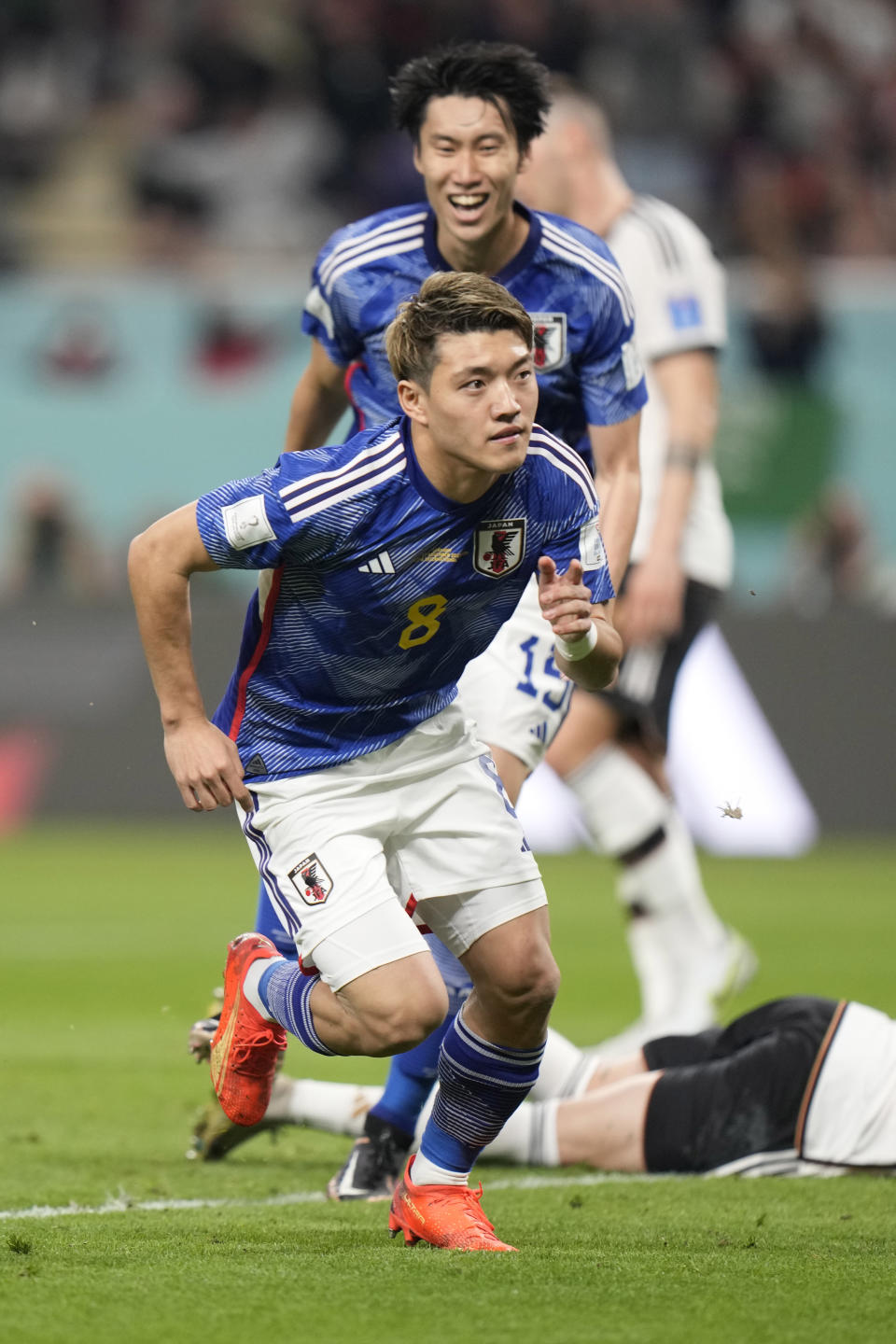 Japan's Ritsu Doan celebrates after scoring his side's opening goal during the World Cup group E soccer match between Germany and Japan, at the Khalifa International Stadium in Doha, Qatar, Wednesday, Nov. 23, 2022. (AP Photo/Luca Bruno)