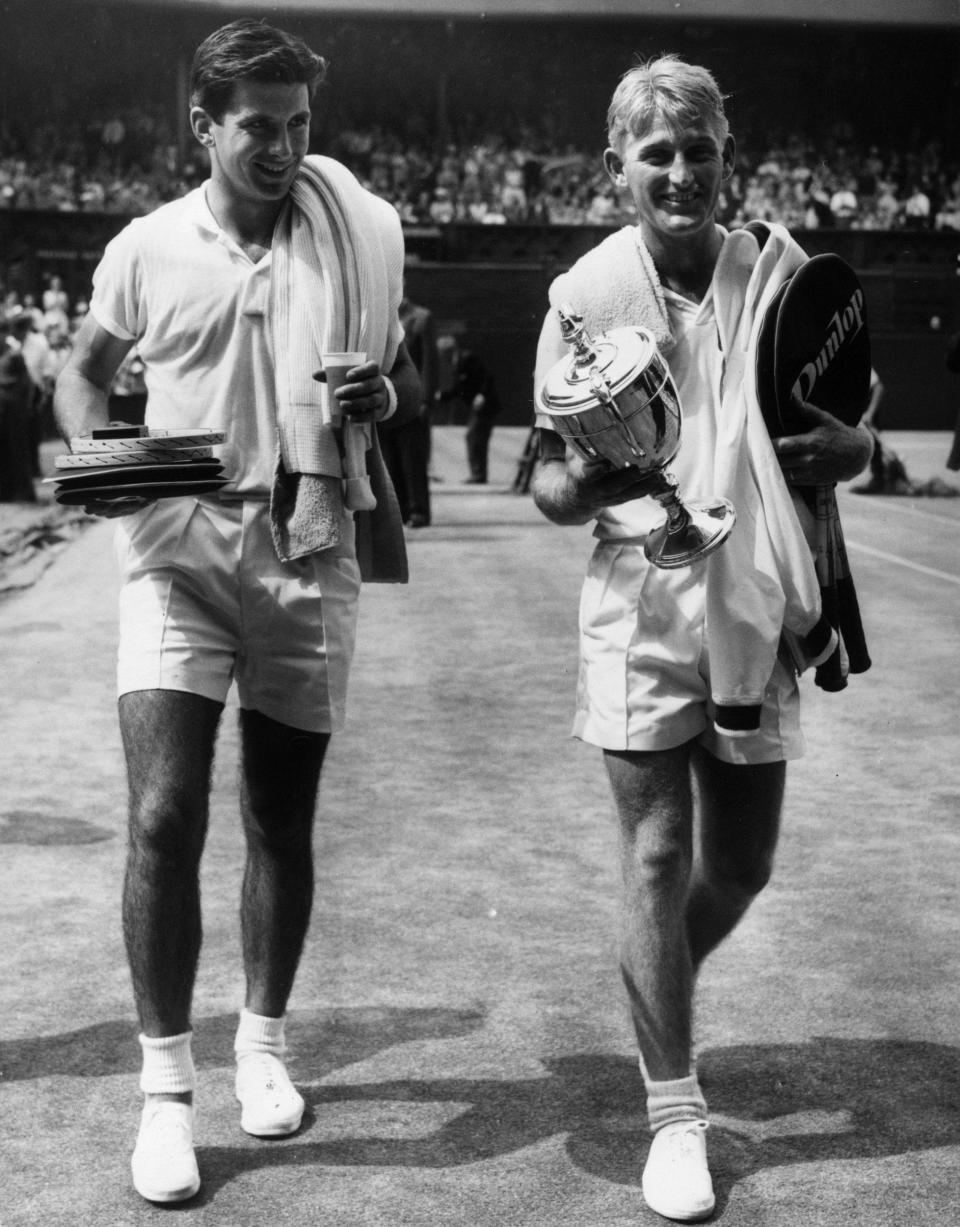 Leaving Centre Court with the victor Lew Hoad after the 1957 Wimbledon singles final - Douglas Miller/Keystone/Getty Images