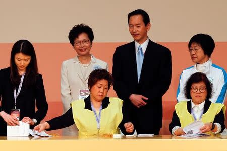 Carrie Lam (2nd L) smiles as officials count votes during the election for Hong Kong's next Chief Executive in Hong Kong, China, March 26, 2017. REUTERS/Bobby Yip