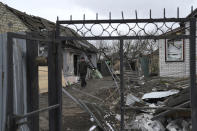 A man walk in a destroyed residential area after a Russian rocket attack in Hlevakha, Kyiv region, Ukraine, Thursday, Jan. 26, 2023. (AP Photo/Roman Hrytsyna)