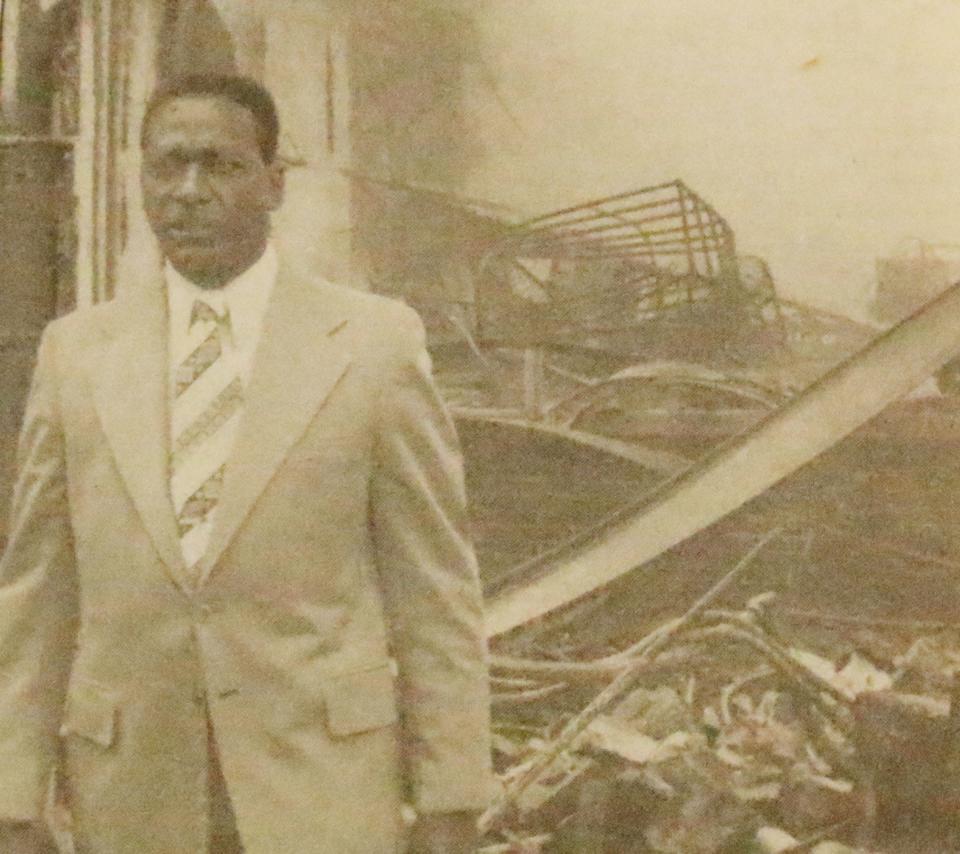 Warden Thaddeus Pinkney walks past the rubble of a burned building that was destroyed during the July 22,1978, riot at Pontiac Correctional Center. Pinkney, the warden at PCC at the time, was not in the area at the time of the riot.