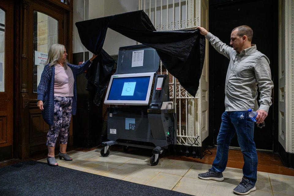 Philadelphia city commissioners display a voting machine in Philadelphia City Hall on Oct. 24, 2022. <a href="https://media.gettyimages.com/photos/philadelphia-city-commissioner-lisa-deeley-and-deputy-comissioner-picture-id1244203987?s=612x612" rel="nofollow noopener" target="_blank" data-ylk="slk:Ed Jones/AFP via Getty Images;elm:context_link;itc:0;sec:content-canvas" class="link ">Ed Jones/AFP via Getty Images</a>