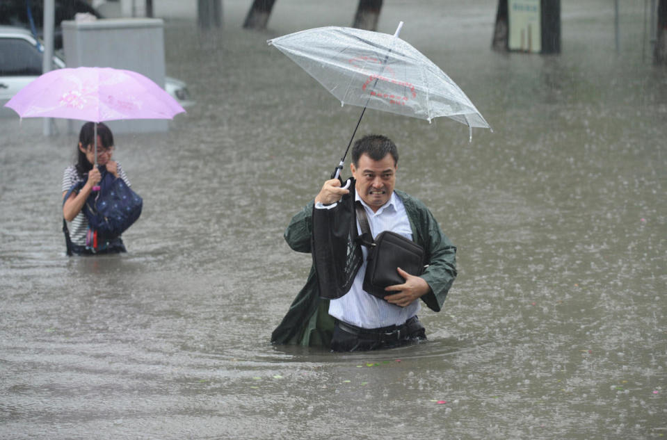 People walk in flooded street in Taiyuan