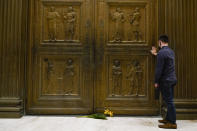 A man touches the door of the Supreme Court Friday, Sept. 18, 2020, in Washington, after the Supreme Court announced that Supreme Court Justice Ruth Bader Ginsburg has died of metastatic pancreatic cancer at age 87. (AP Photo/Alex Brandon)