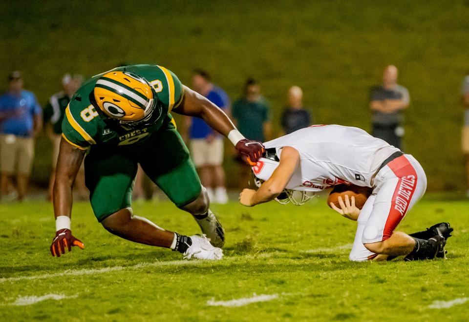 Crest senior defensive end Eli Hall sacks Newton-Conover junior quarterback Jason Brawley during the final scrimmage of the Cleveland County Football Jamboree Friday night at Burns High School in Lawndale, N.C.