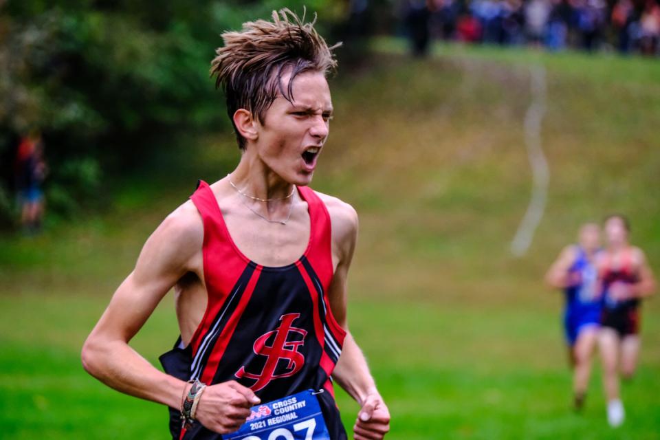 St. Johns junior, Joey Bowman celebrates his first-place finish in the D2 Boys Cross Country Regional Friday, Oct. 29, 2021.