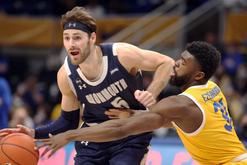 Monmouth Hawks guard George Papas (5) drives to the basket against pressure from Pittsburgh Panthers guard Onyebuchi Ezeakudo (31) during the second half at the Petersen Events Center. Monmouth won 56-52.