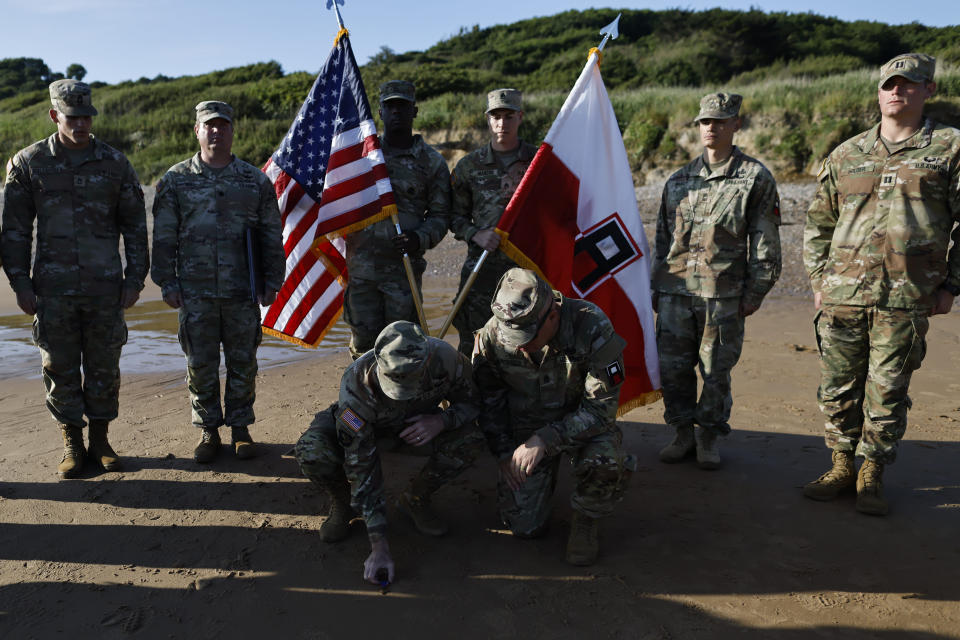 Soldiers of the First U.S. Army hold a ceremony on Omaha Beach in Colleville-sur-Mer, France on Friday, June 7, 2024, to honor Waverly Woodson Jr., a medic who was part of the only Black combat unit to take part in the D-Day invasion of France during World War II, being posthumously awarded the Distinguished Service Cross in recognition of the heroism and determination he showed treating troops under heavy enemy fire. The Distinguished Service Cross is the second-highest honor that can be bestowed on a member of the Army and is awarded for extraordinary heroism. (AP Photo/Jeremias Gonzalez)