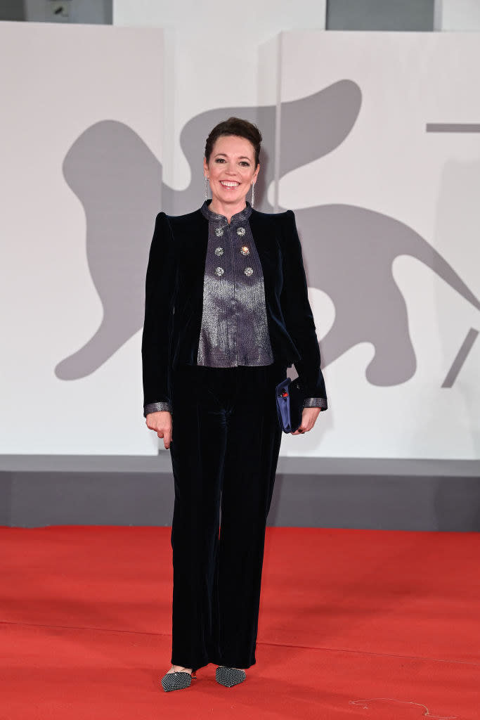 Olivia Colman wearing a plush navy velvet suit with silver trimmings on the red carpet for "The Lost Daughter"