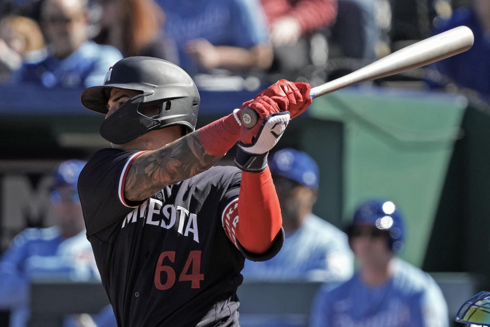 Minnesota Twins' Jose Miranda hits an RBI single during the first inning of a baseball game against the Kansas City Royals Saturday, April 1, 2023, in Kansas City, Mo. (AP Photo/Charlie Riedel)