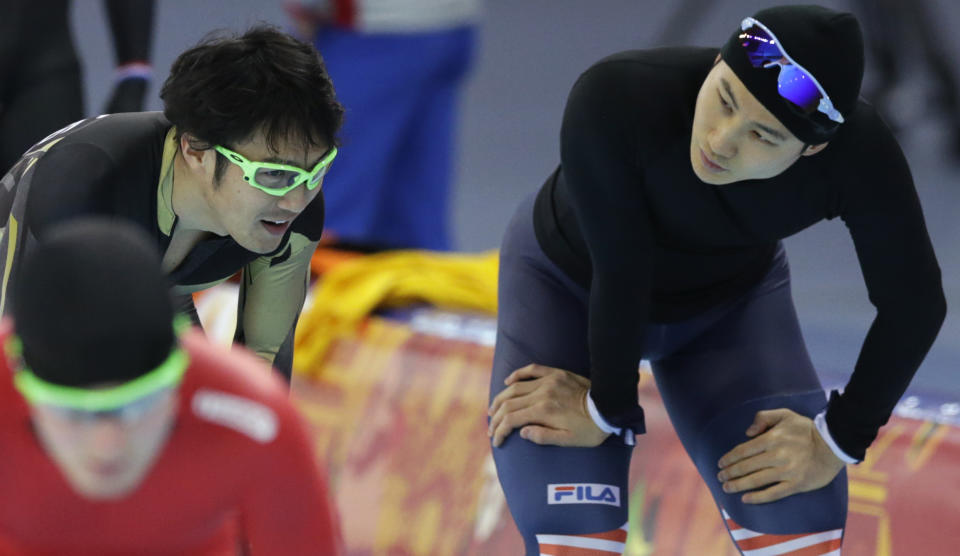 CORRECTS NAME OF SOUTH KOREAN SPEEDSKATER - South Korean speedskater Lee Kang-seok, right, and Joji Kato of Japan interact between training at the Adler Arena Training Center during the 2014 Winter Olympics in Sochi, Russia, Friday, Feb. 7, 2014. (AP Photo/Matt Dunham)