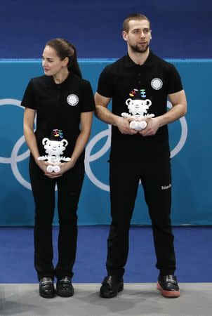 Curling – Pyeongchang 2018 Winter Olympics – Mixed Doubles Bronze Medal Match - Olympic Athletes from Russia v Norway - Gangneung Curling Center - Gangneung, South Korea – February 13, 2018 - Alexander Krushelnitsky and Anastasia Bryzgalova, Olympic athletes from Russia, during the victory ceremony. REUTERS/Cathal McNaughton