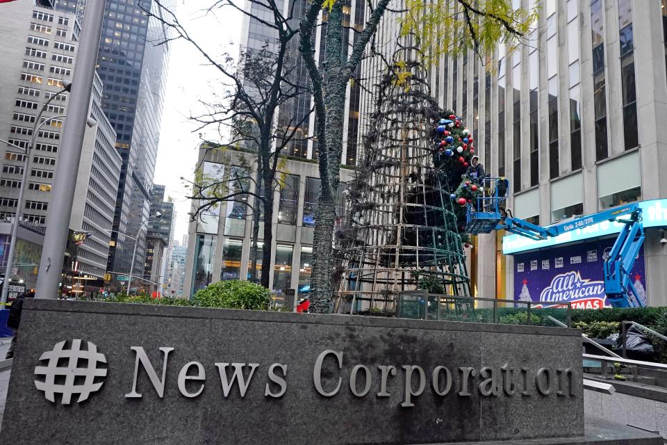 A worker disassembles a Christmas tree outside Fox News headquarters, in New York, Wednesday, Dec. 8, 2021. Police say a man is facing charges including arson for setting fire to a 50-foot Christmas tree in front of Fox News headquarters in midtown Manhattan. The tree outside of the News Corp. building that houses Fox News, The Wall Street Journal and the New York Post caught fire early Wednesday. (AP Photo/Richard Drew)