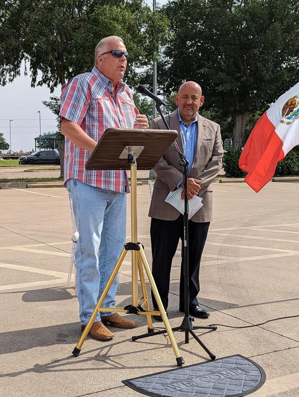 Arlington Mayor Jim Ross, joined by city councilman Raul Gonzalez, speaks at the unveiling of the Dolores Huerta street topper on May 27.