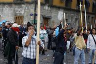 Protesters look up at helicopters of the federal police flying over the Zocalo in Mexico City September 13, 2013. (REUTERS/Tomas Bravo)