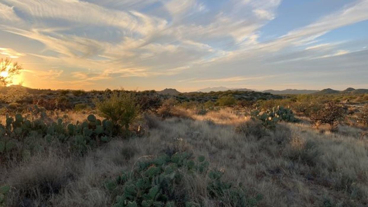 <div>The wispy clouds dance over the desert hills in Palo Verde! Thanks to Dion Romero for sending us this photo!</div>