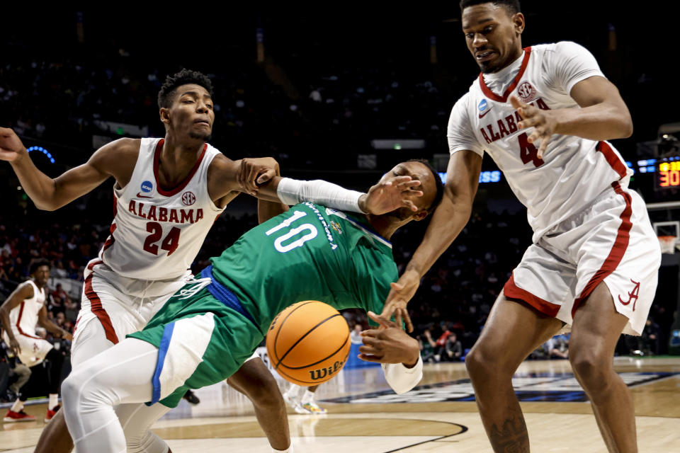 Texas A&M-CC forward Isaac Mushila (10) is fouled by Alabama forward Brandon Miller (24) as they reach for a rebound in the second half of a first-round college basketball game in the NCAA Tournament in Birmingham, Ala., Thursday, March 16, 2023. Alabama won 96-75. (AP Photo/Butch Dill)