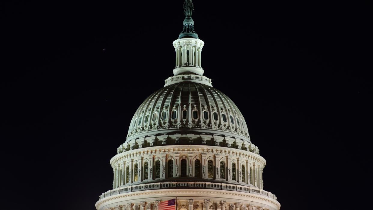  The white dome of the u.s. capitol building is lit up at night. 