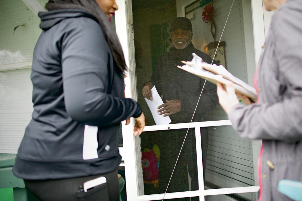 Tawanya Herbert, left, canvasses for 