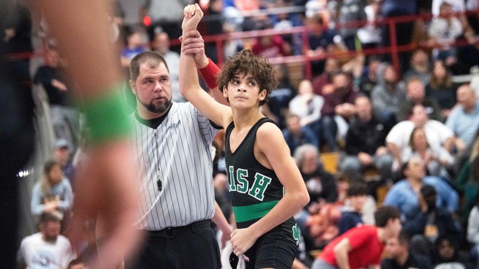 Camden Catholic's Lazarus Joyce has his arm raised after defeating Haddonfield's Michael Lamb, 5-4, during a 106 lb. bout of the quarterfinal round of the Region 7 wrestling tournament at Cherry Hill East High School  on Friday, February 24, 2023.  
