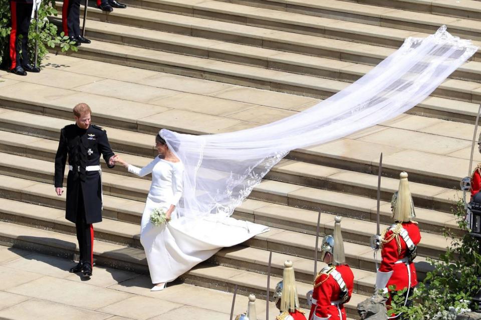 Meghan's delicate veil was five metres long and made from silk tulle with a trim of hand-embroidered flowers in silk threads and organza (PA )