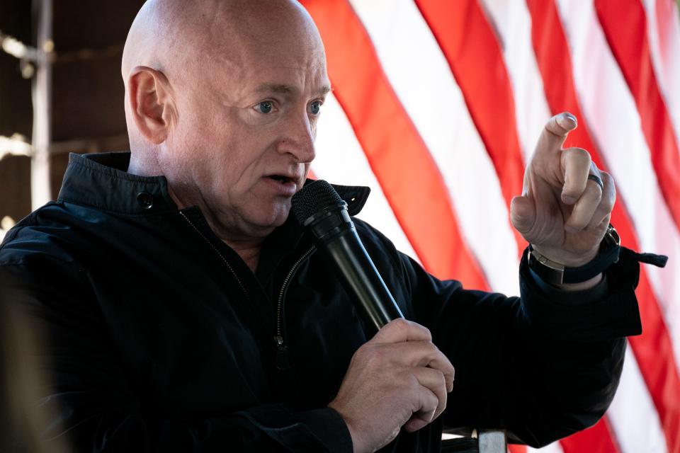 U.S. Sen. Mark Kelly answers a question during a press conference, Jan. 18, 2022, in the Binns Wildflower Pavilion at the Desert Botanical Garden in Phoenix.