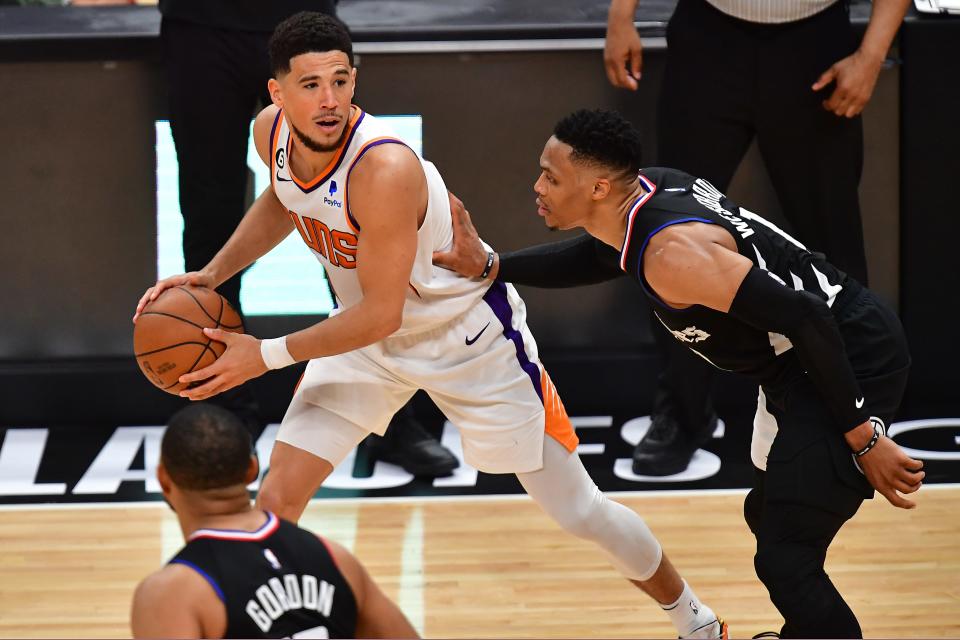 Phoenix Suns guard Devin Booker (1) controls the ball against Los Angeles Clippers guard Russell Westbrook (0) during the second half in game four of the 2023 NBA playoffs at Crypto.com Arena on April 22, 2023.