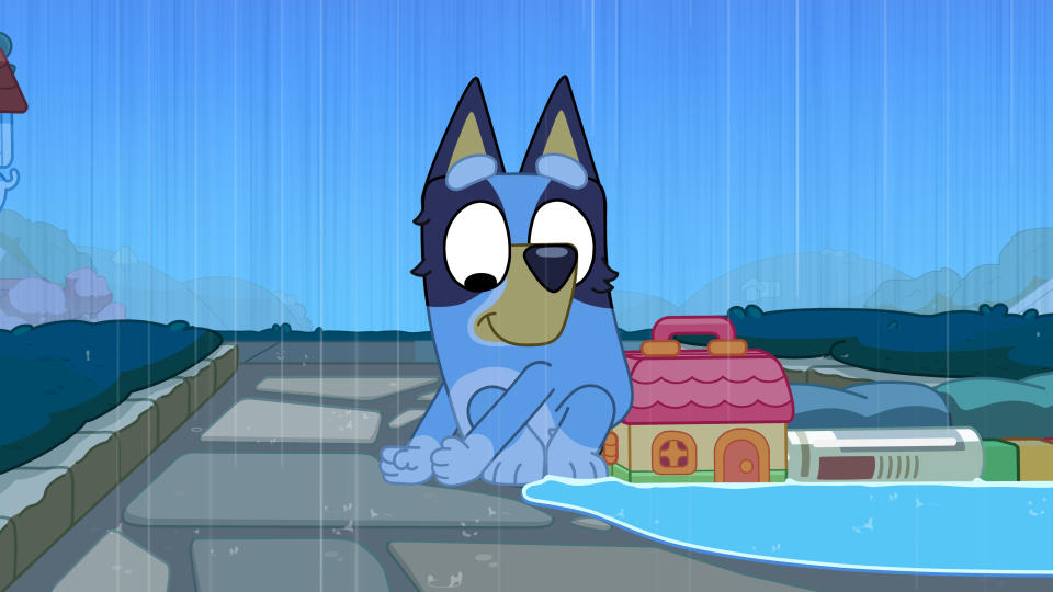 Picture Shows: Blueyâ€™s using a newspaper, her toys and her hands to dam the stream of rainwater, but itâ€™s not enough!