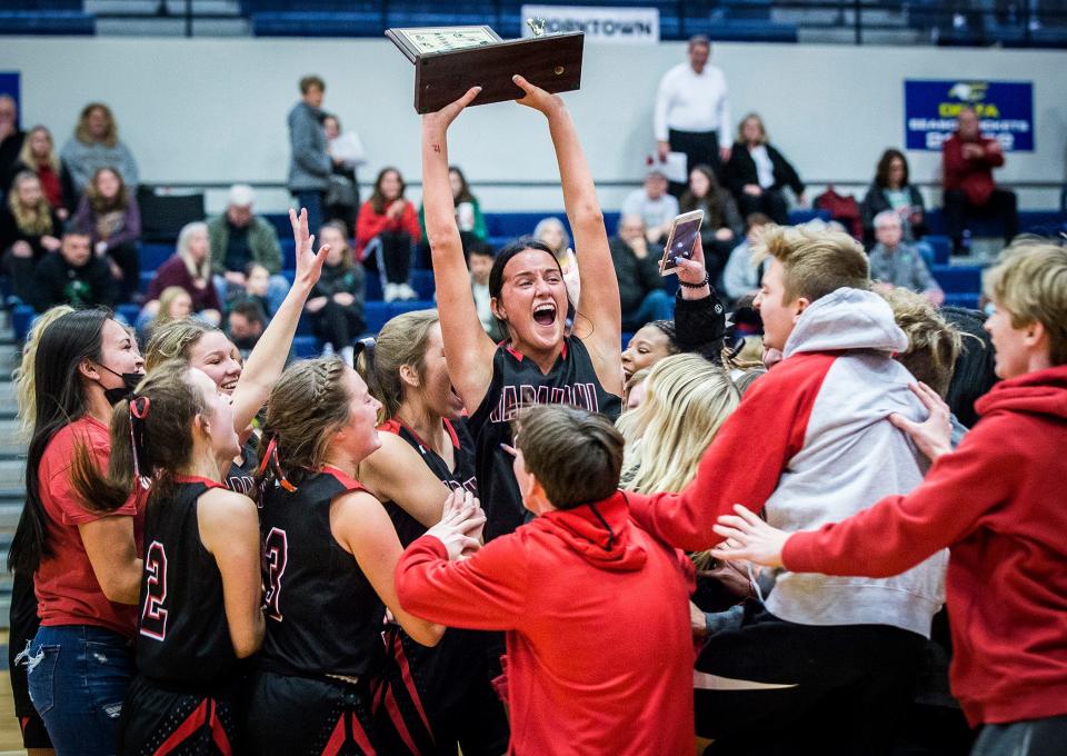 Wapahani senior Lala Lee raises the Delaware County championship trophy after beating Yorktown during their championship game at Delta High School Saturday, Jan. 15, 2022.