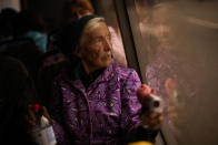 Kateryna Hodza, 85, takes a bus from a reception center for displaced people in Zaporizhzhia, Ukraine, Friday, April 29, 2022. They fled from Mala Tokmachka, in Zaporizhzhia region, as thousands of Ukrainian continue to leave Russian occupied areas. (AP Photo/Francisco Seco)