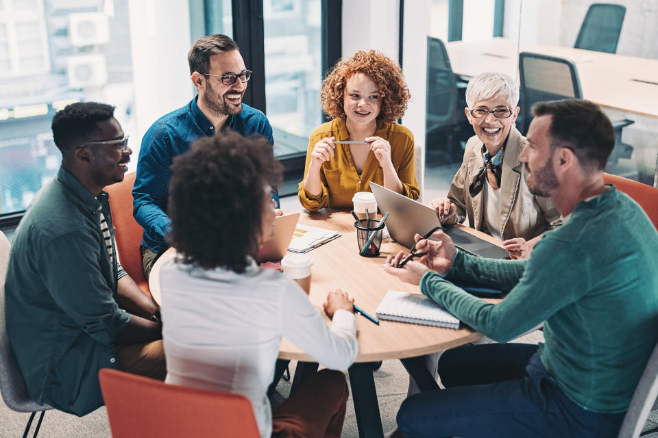 group of business people young and old having a meeting