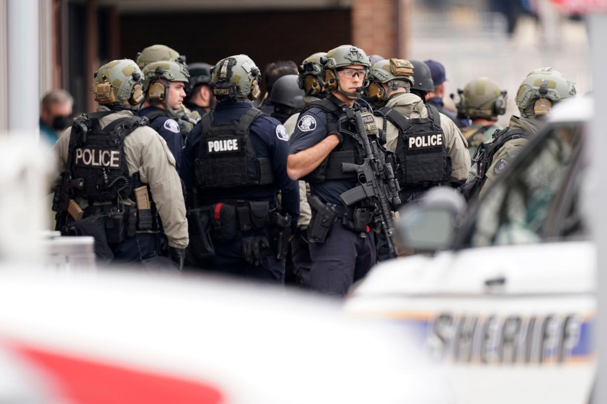 Police stand outside a King Soopers grocery store where a shooting took place Monday, March 22, 2021, in Boulder, Colo.