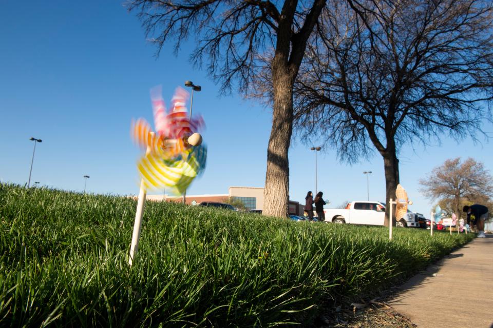 The Community Partners of Lubbock placed pinwheels outside of the 50th Street Market Street with volunteers for Pinwheels for Prevention to raise awareness of child abuse on Saturday, March 27, 2021, in Lubbock, Texas.