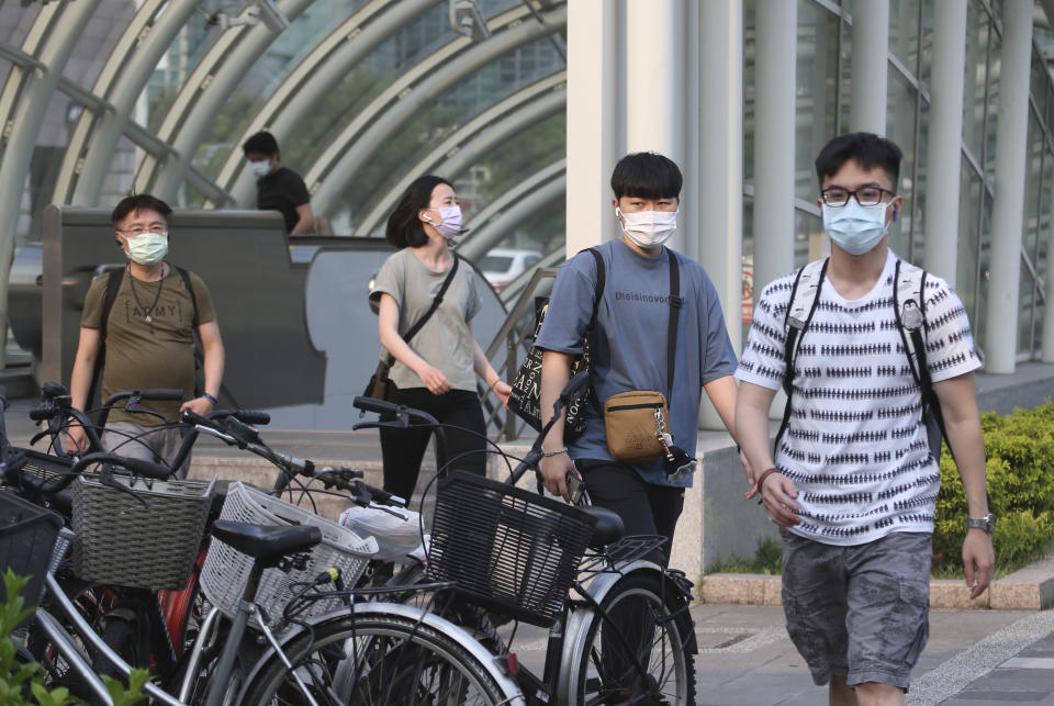 People wear face masks to protect against the spread of the coronavirus after the COVID-19 alert raise to level 3 in Taipei, Taiwan, Saturday, May 15, 2021. Taiwan, which has had enviable success in containing COVID-19, imposed new restrictions in its capital city on Saturday as it battled its worst outbreak since the pandemic began. (AP Photo/Chiang Ying-ying)