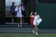 Tunisia's Ons Jabeur, foreground and Kazakhstan's Elena Rybakina walk out for the final of the women's singles on day thirteen of the Wimbledon tennis championships in London, Saturday, July 9, 2022. (AP Photo/Alastair Grant)