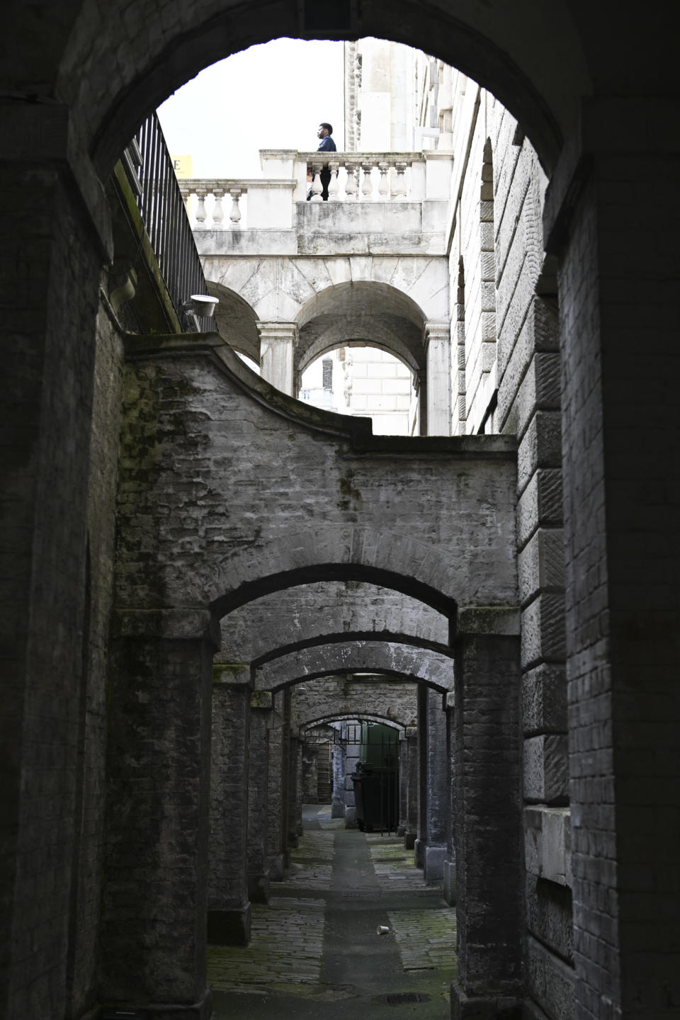 Shadowed archway under overcast light