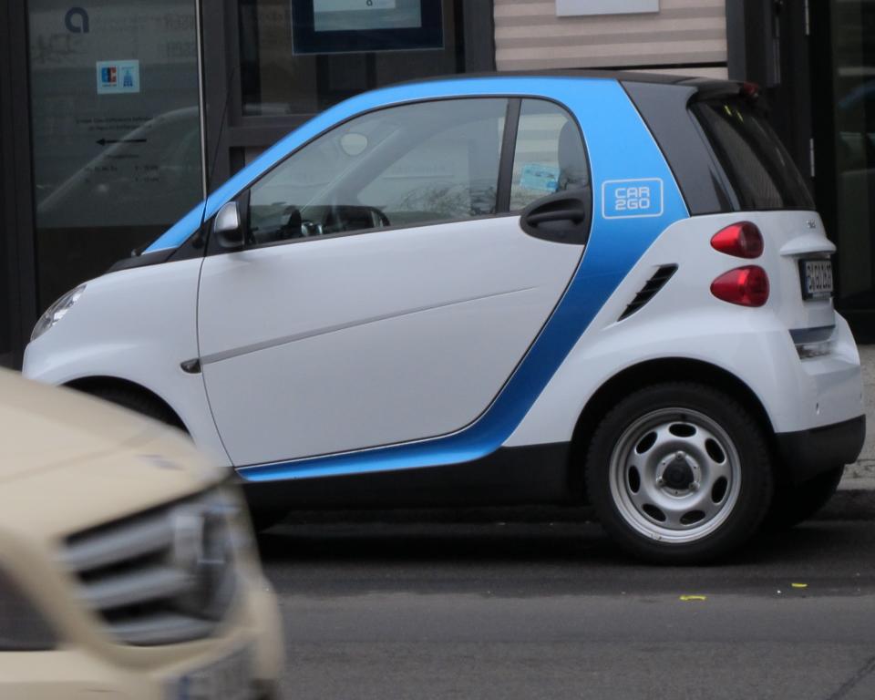 A Car2Go vehicle is parked on a street in central Berlin on Wednesday, Feb. 19, 2014. The service, operated by Mercedes-Benz and Smart car manufacturer Daimler launched a new intercity service recently. (AP Photo/Frank Jordans)
