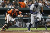 Jul 9, 2018; Baltimore, MD, USA; Baltimore Orioles catcher Chance Sisco (15) reaches for a tag on New York Yankees right fielder Aaron Judge (99) after a strikeout in the seventh inning at Oriole Park at Camden Yards. Mandatory Credit: Geoff Burke-USA TODAY Sports