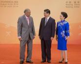Chinese President Xi Jinping (C) and wife Peng Liyuan (R) smile at Fiji's President Epeli Nailatikau during a reception for country leaders and officials at the Purple Palace, ahead of the 2014 Nanjing Youth Olympic Games opening ceremony, in Nanjing, August 16, 2014. REUTERS/Rolex Dela Pena/Pool