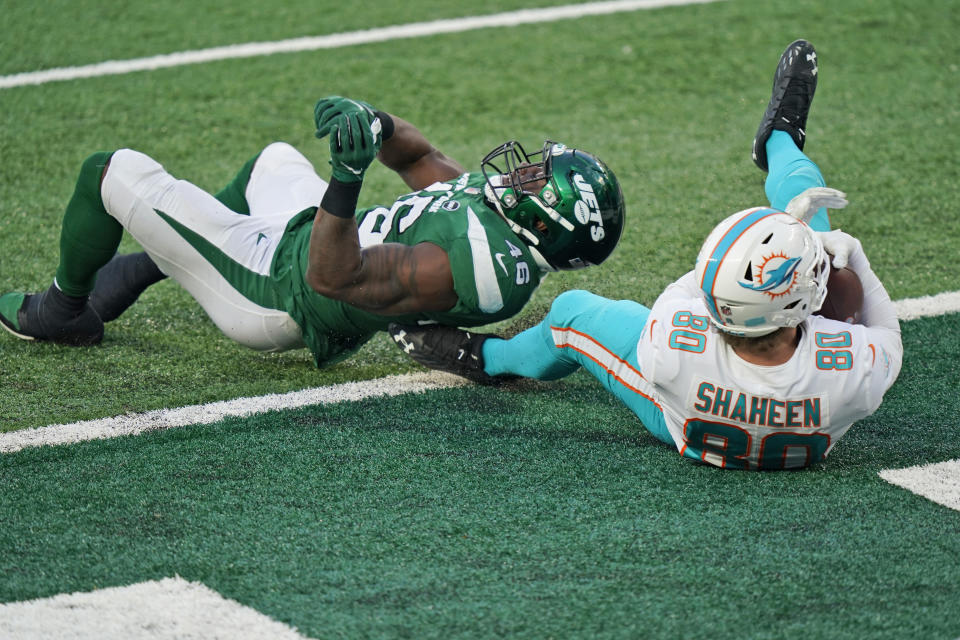 Miami Dolphins' Adam Shaheen, right, catches a touchdown pass in front of New York Jets' Neville Hewitt during the second half of an NFL football game, Sunday, Nov. 29, 2020, in East Rutherford, N.J. (AP Photo/Corey Sipkin)